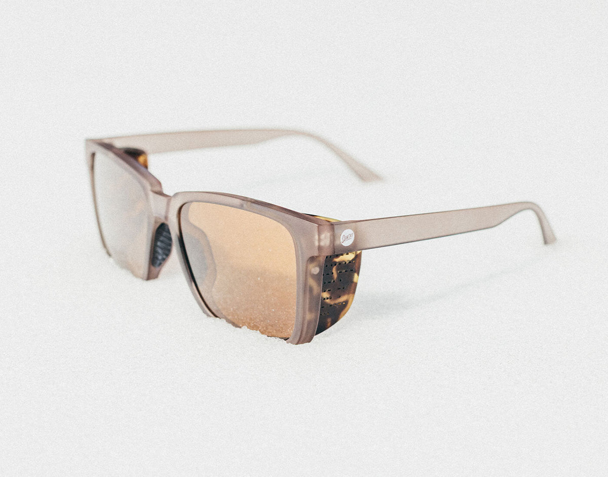 STORY Sunglasses with a tortoiseshell frame on a light gray background