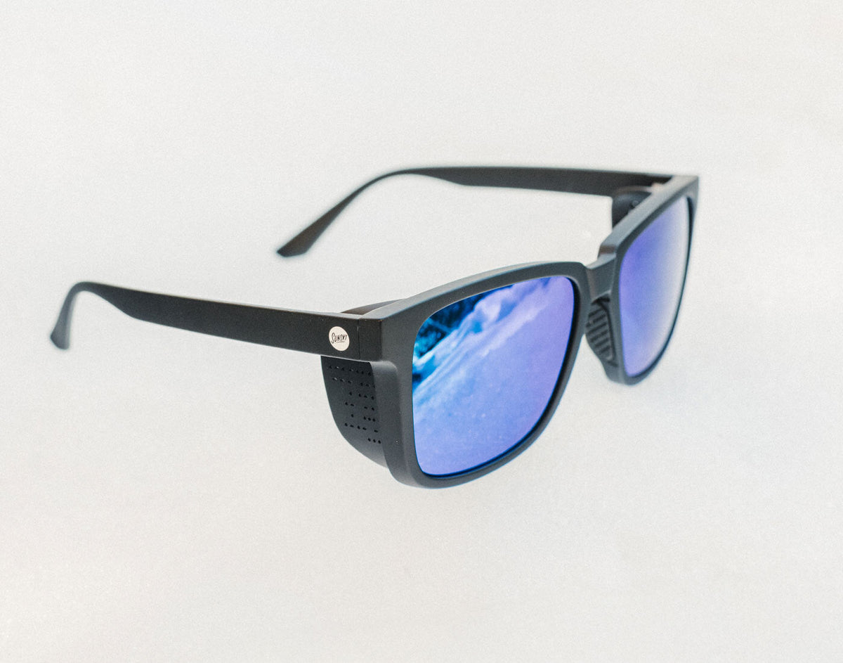 STORY Black sunglasses with blue lenses on a light gray background