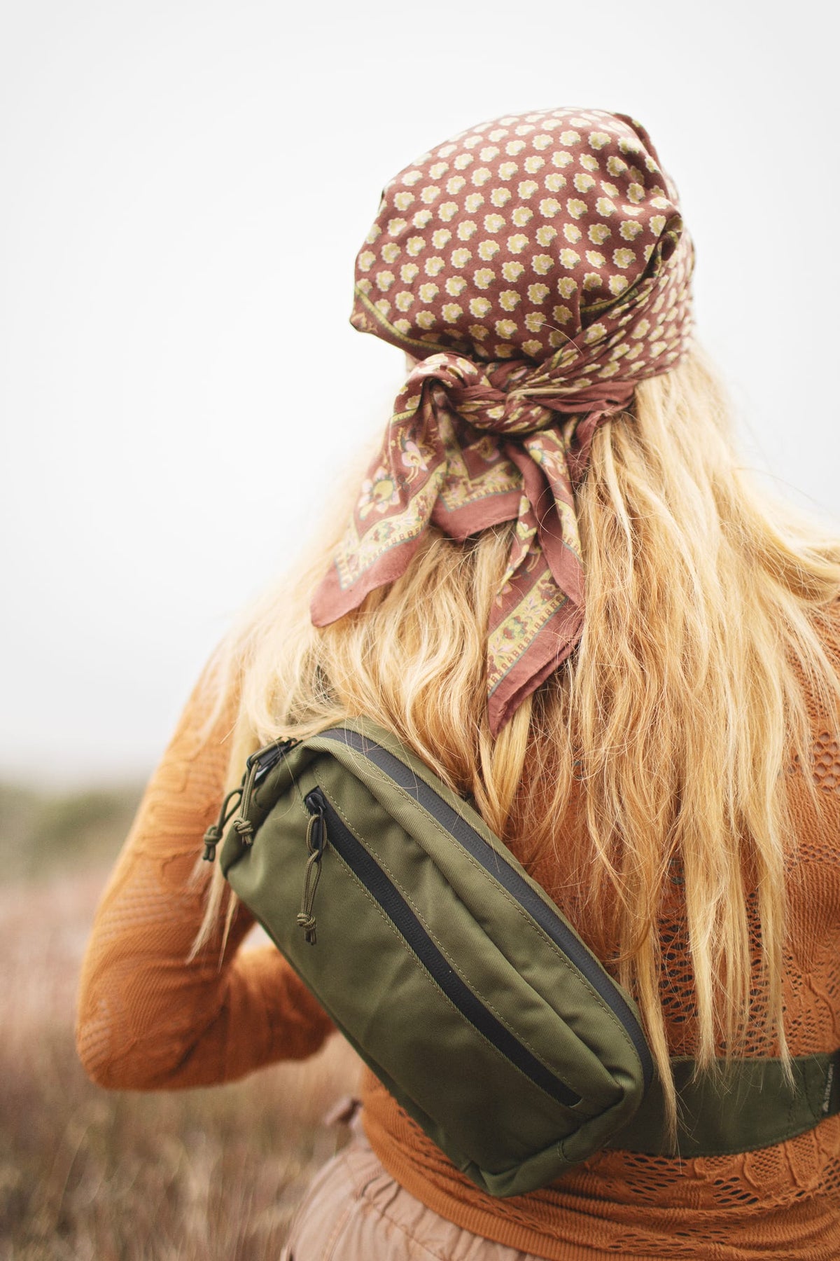 Person wearing Everyday Fanny Pack (Fern) crossbody in a outdoor setting, showcasing versatility and style.