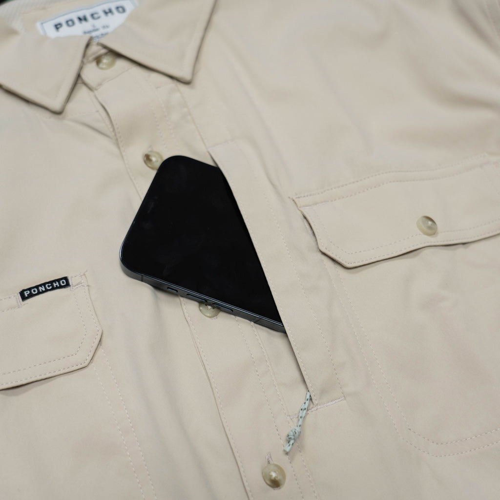 tan shirt cell pocket close up