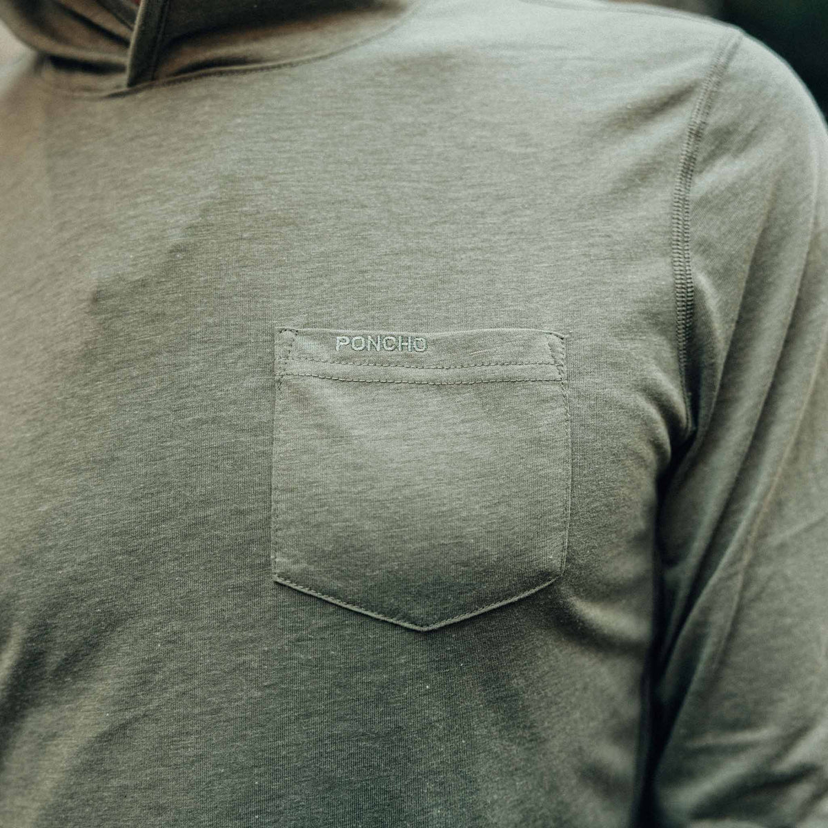 closeup of pocket on moss green hoodie