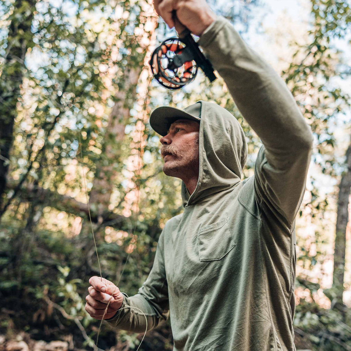 guy casting wearing moss green performance shirt