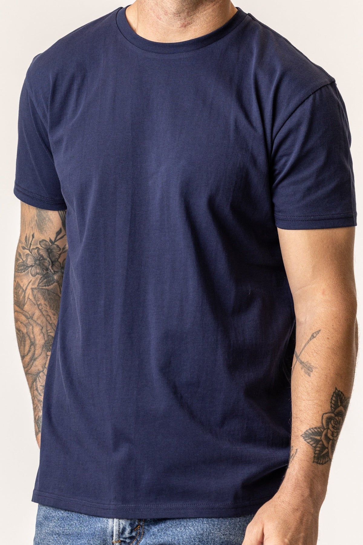 Person wearing a plain organic cotton navy blue t-shirt#color_navy-blue