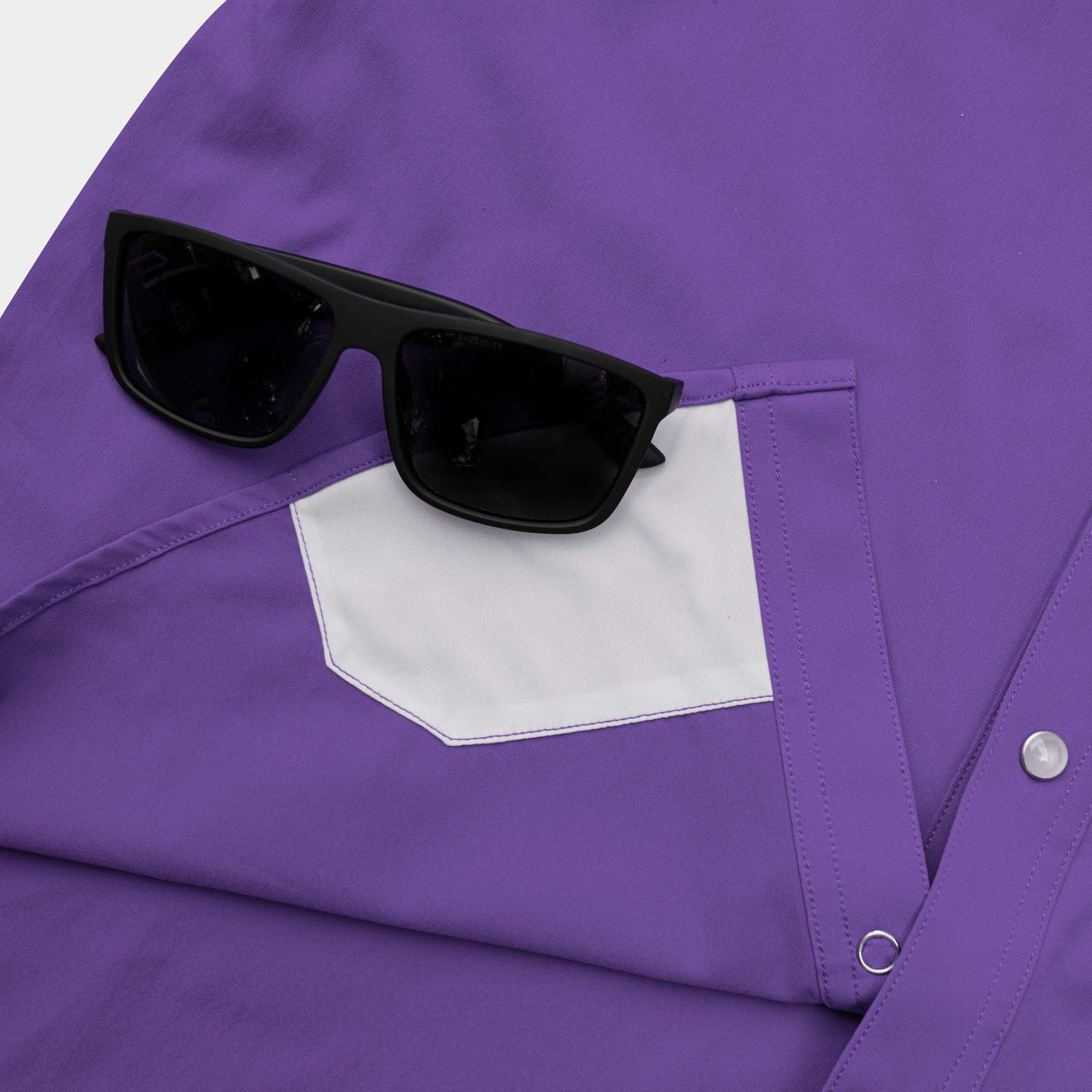 closeup of lens cloth on bottom of shirt
