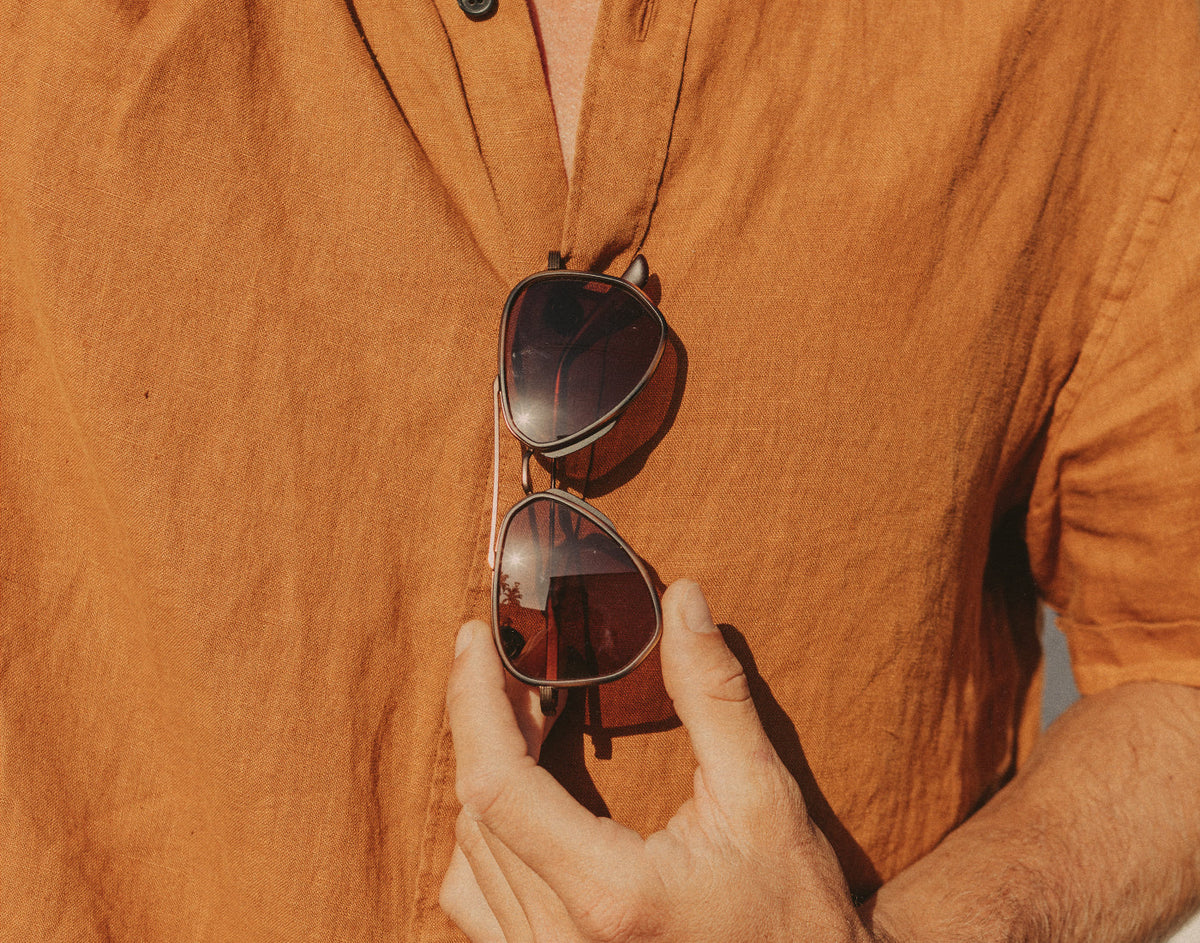 STORY guy holding sunski astra sunglasses