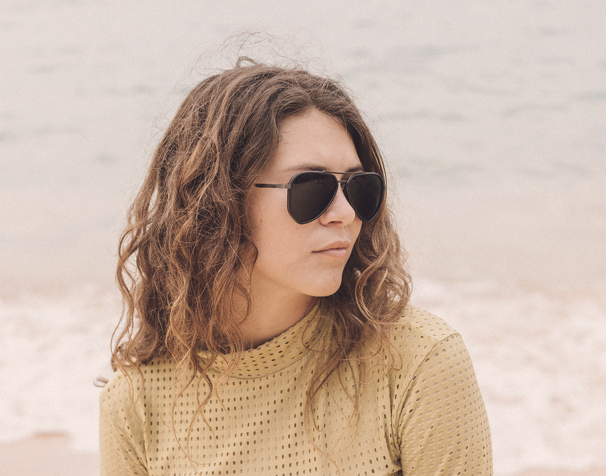STORY profile of girl on the beach wearing sunski astra sunglasses