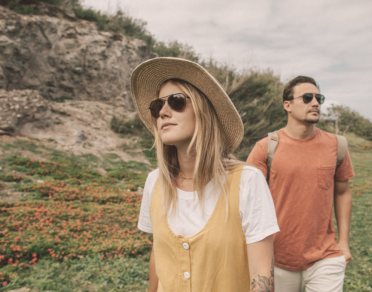 STORY guy and girl wandering wearing sunski astra sunglasses
