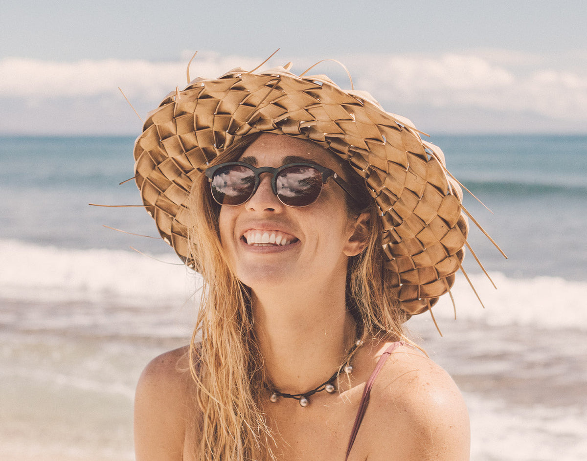 STORY girl in hat laughing wearing sunski avila sunglasses