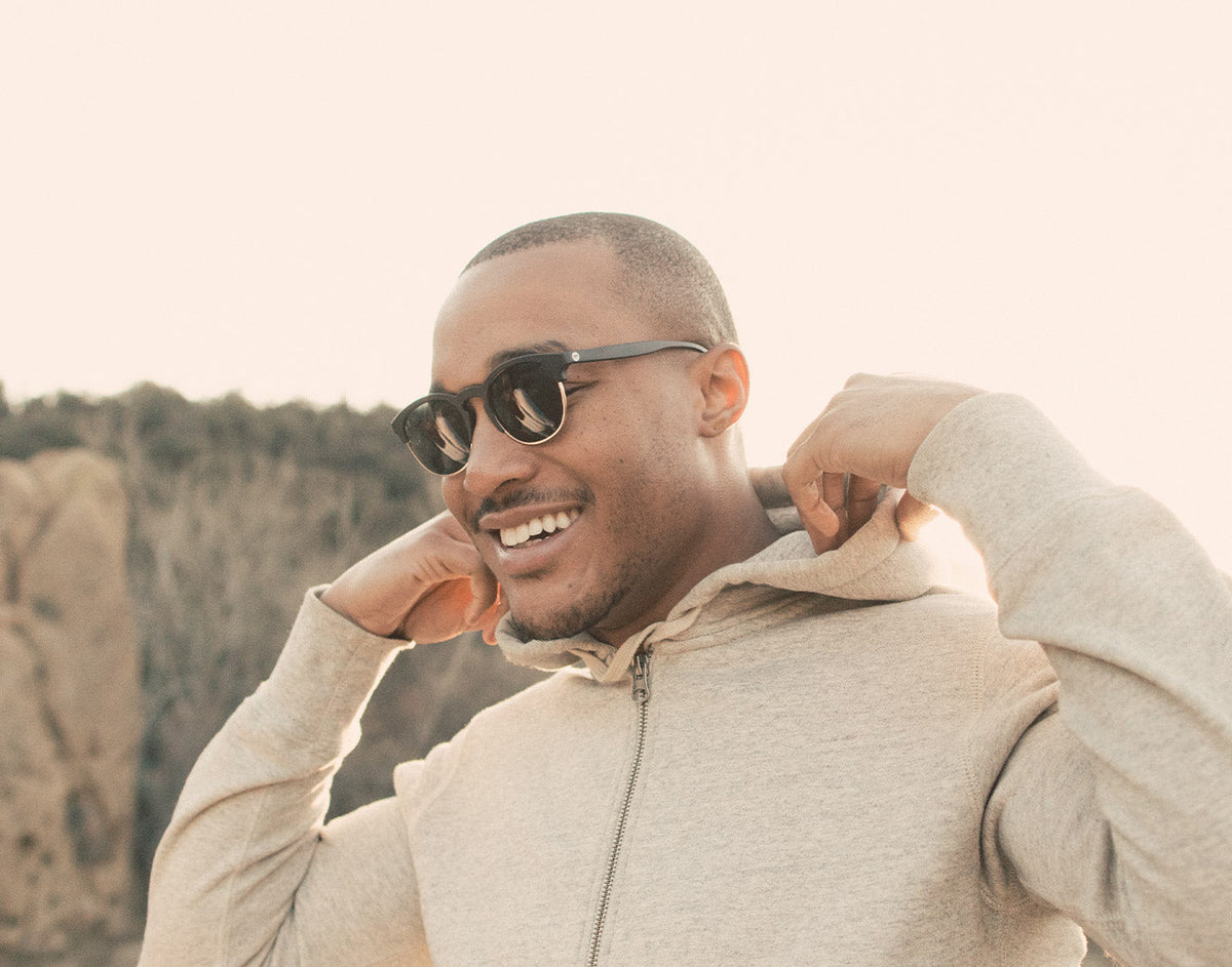 STORY guy in hoodie wearing sunski avila sunglasses