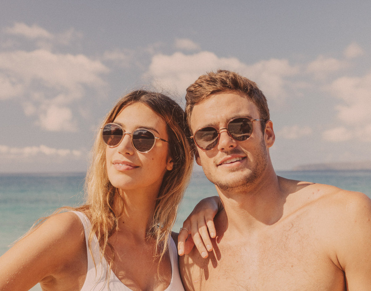 STORY guy and girl wearing sunski baia sunglasses