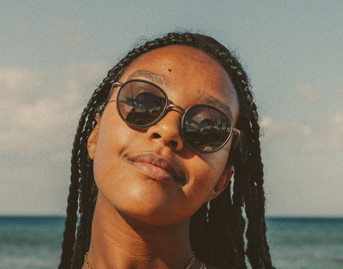 STORY woman soaking in the sun wearing usnski baia sunglasses