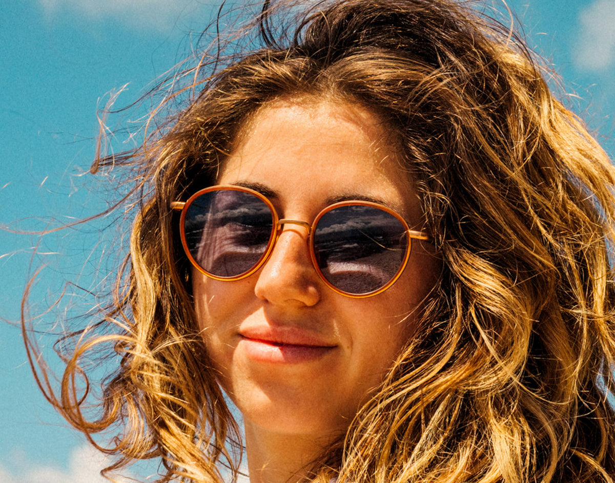 STORY girl soft smiling wearing sunski baia sunglasses