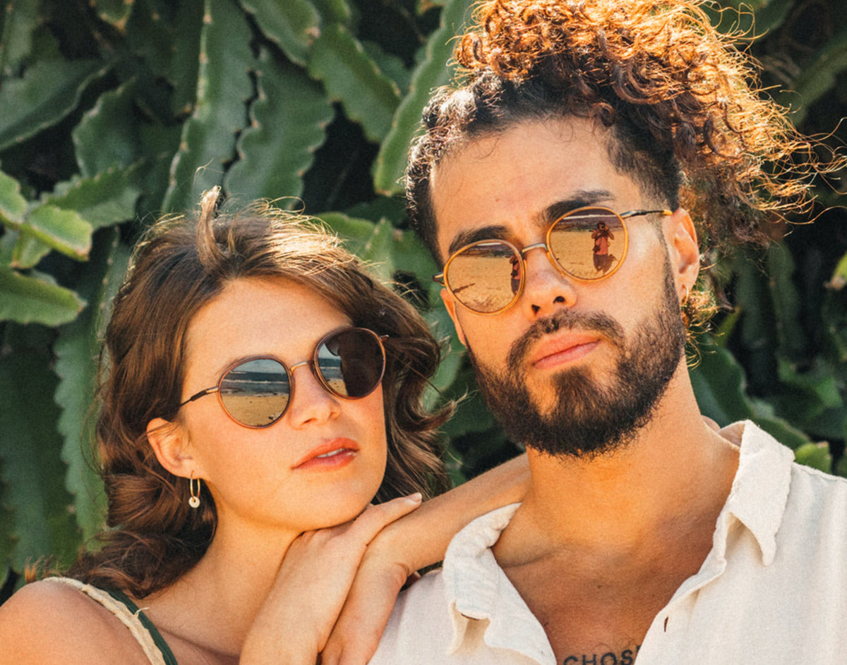 STORY man and woman looking seriously at the camera wearing sunski baia sunglasses