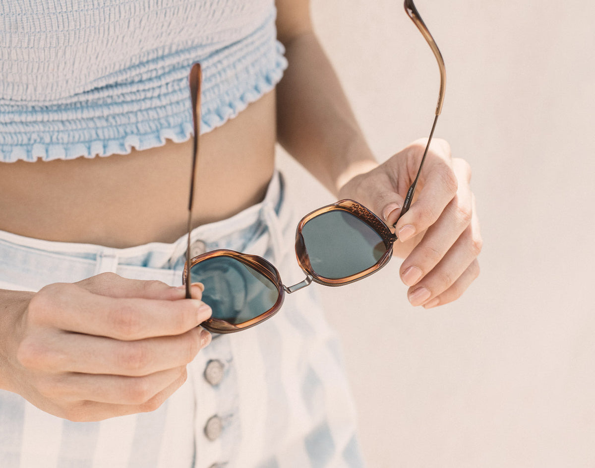 STORY hands holding unfolded sunski bernina sunglasses