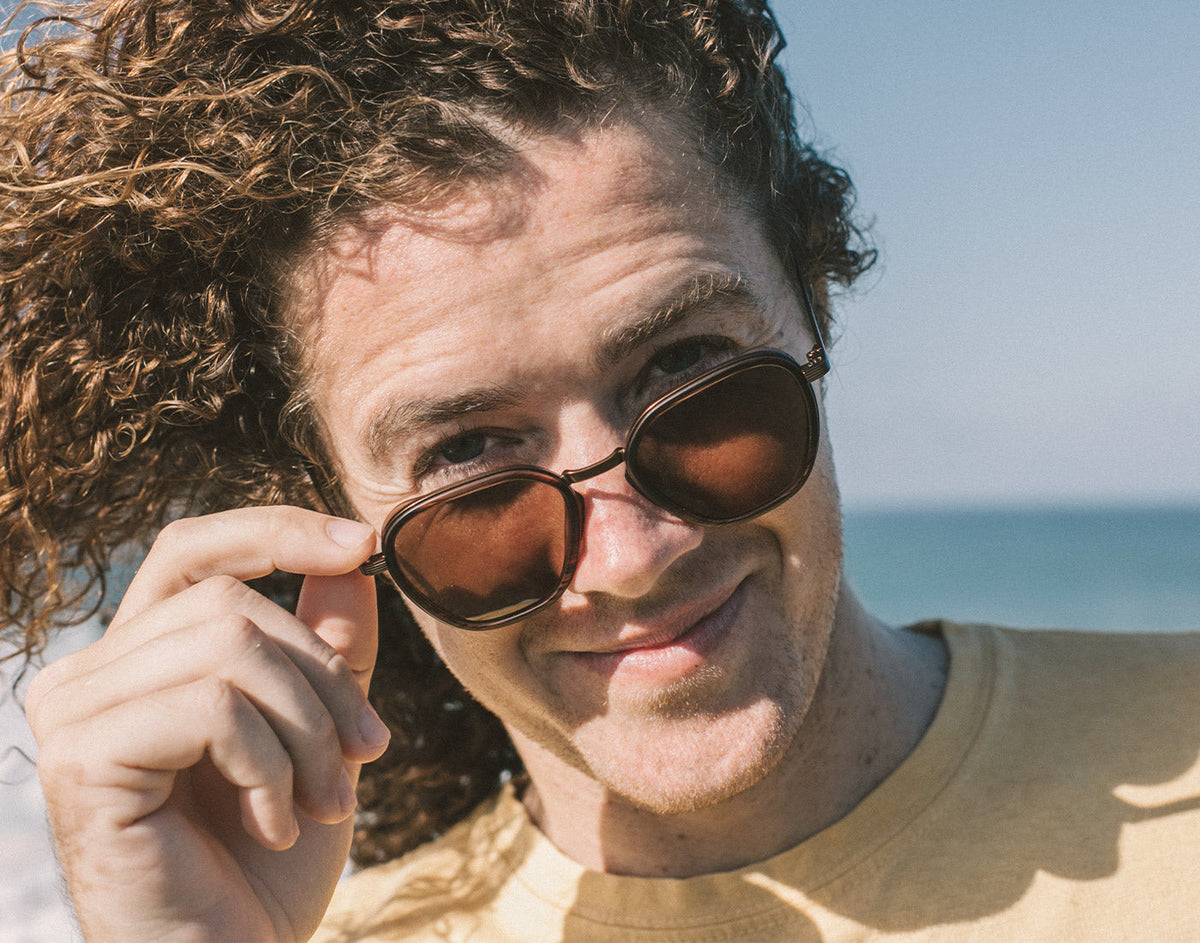 STORY guy looking over the top of sunski bernina sunglasses