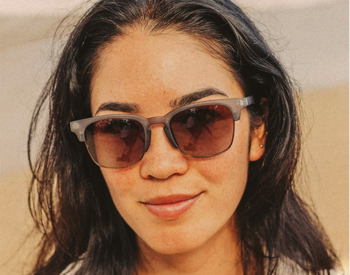 STORY girl wearing sunski cambria navy amber sunglasses