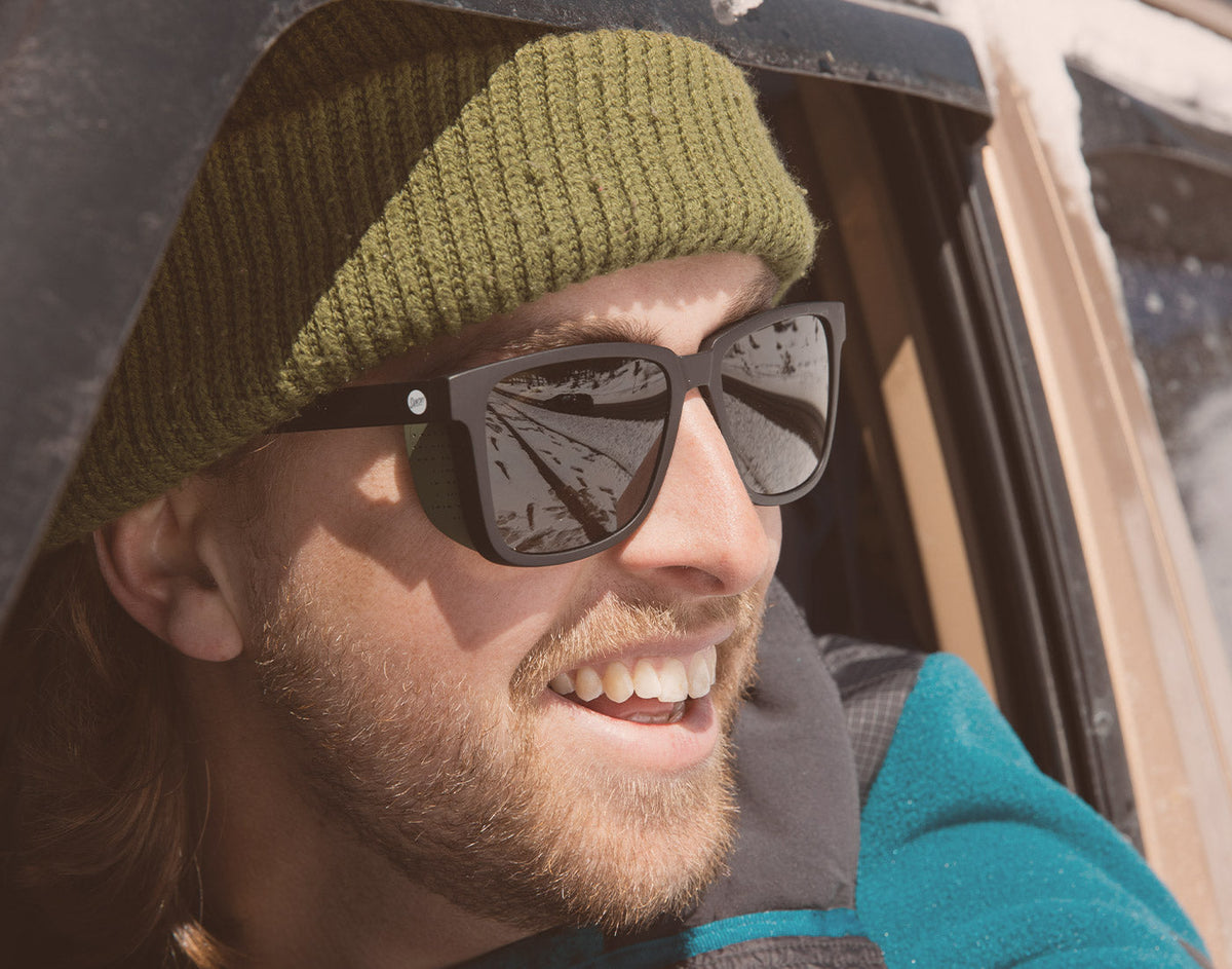 STORY close up of guy out car window wearing sunski couloir sunglasses