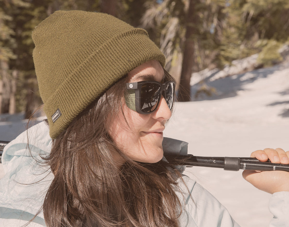 STORY side profile of girl holding ski poles wearing sunski couloir sunglasses