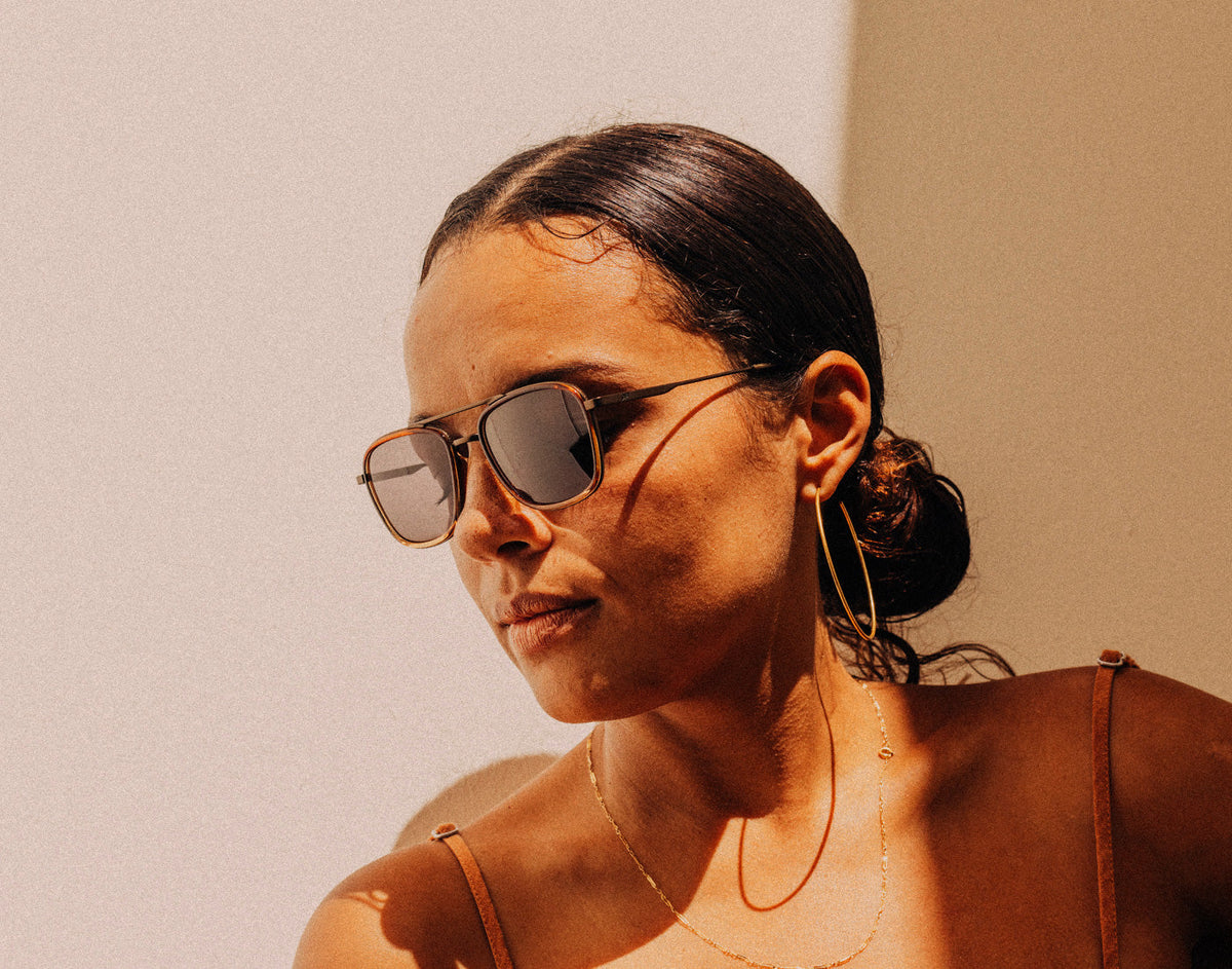 STORY woman looking down wearing sunski estero sunglasses