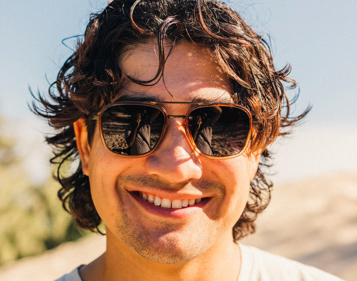 STORY guy smiling wearing sunski estero sunglasses