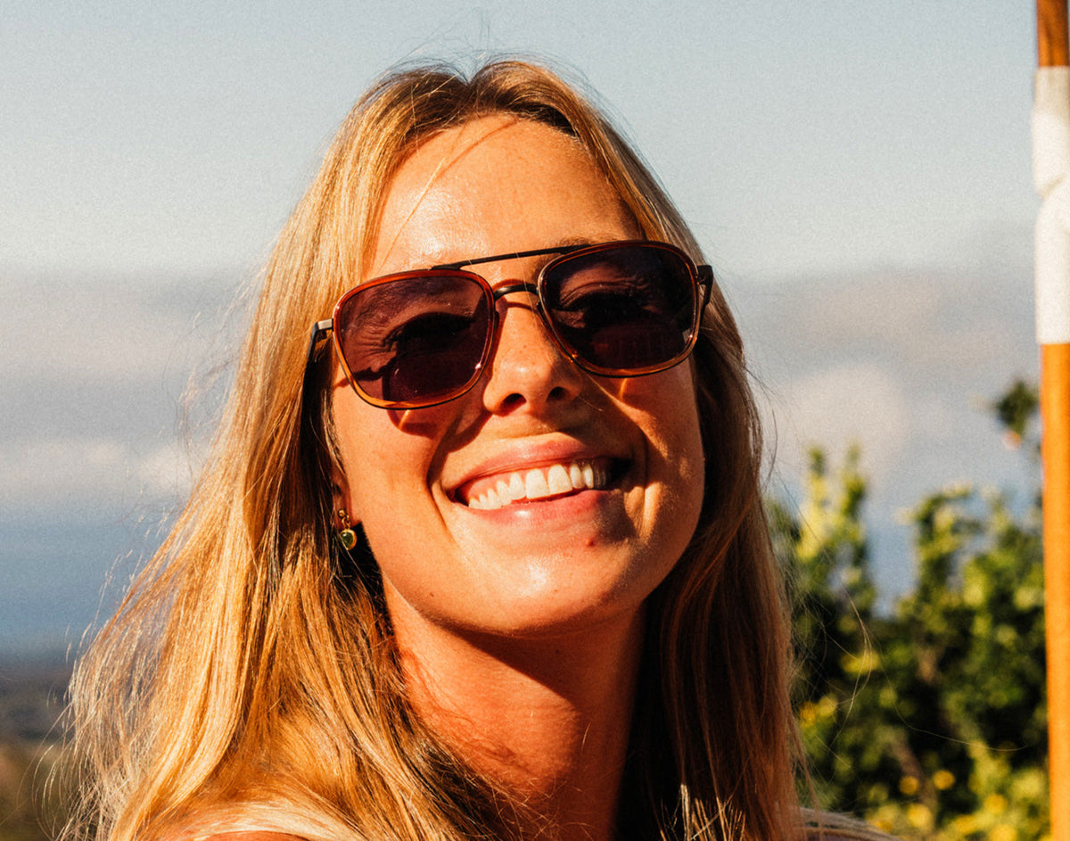 STORY girl smiling wearing sunski estero sunglasses