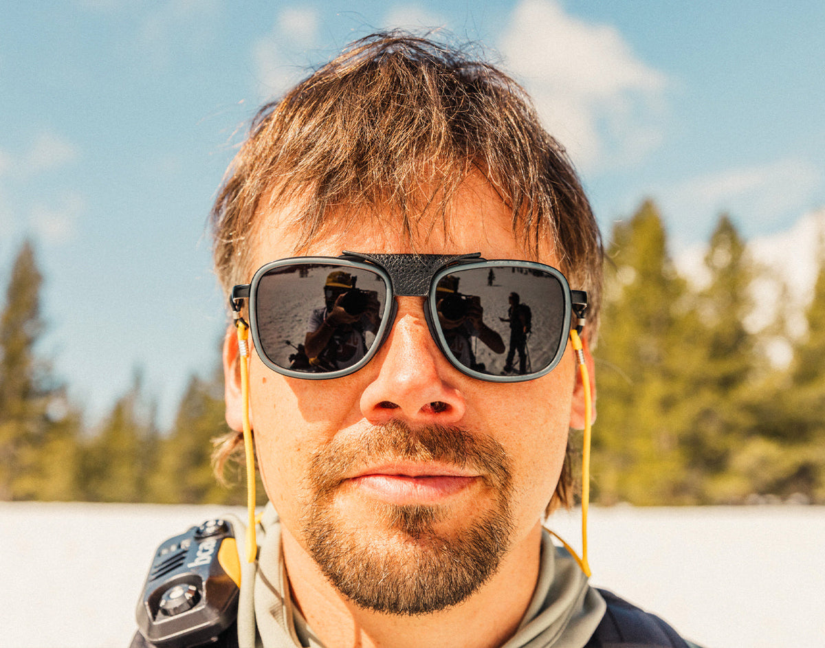 STORY guy looking at the camera with a straight face wearing sunski ferrata sunglasses