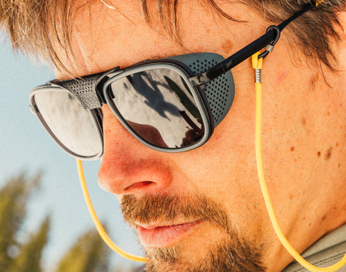 STORY profile of guy looking down wearing sunski ferrata sunglasses