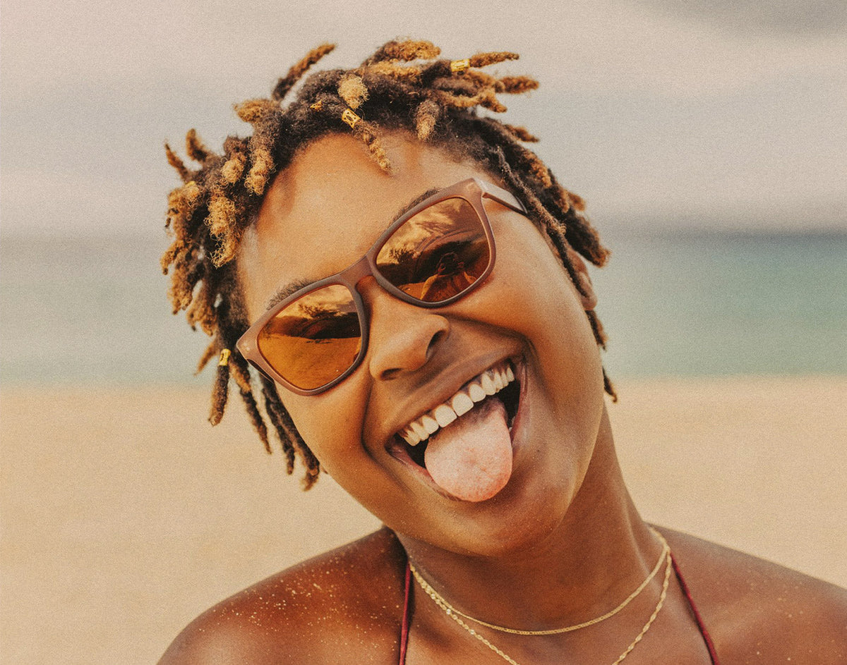 STORY woman sticking her tongue out wearing sunski headland sunglasses