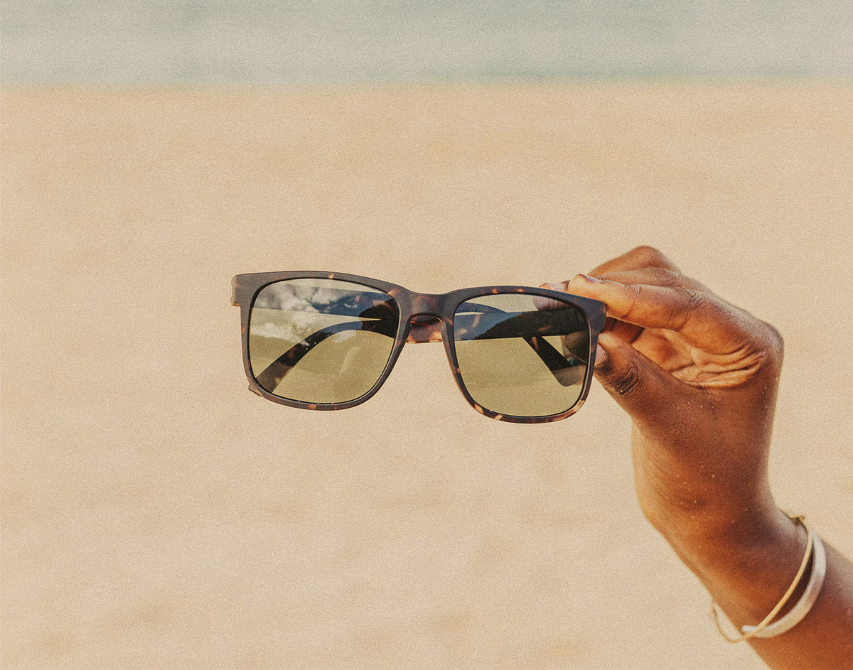 STORY hand holding sunski kiva sunglasses