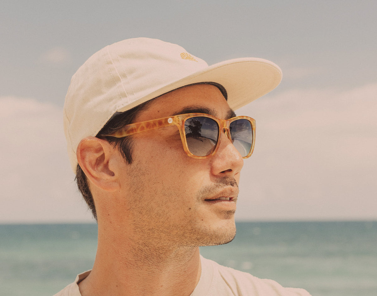 STORY profile of guy in hat wearing sunski madrona sunglasses