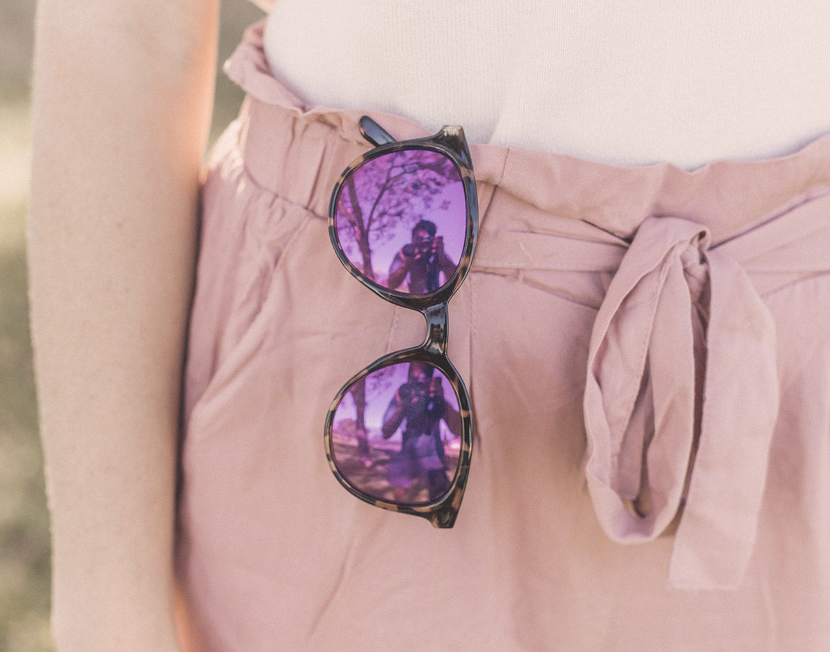 STORY sunski makani sunglasses hanging on shorts waistband