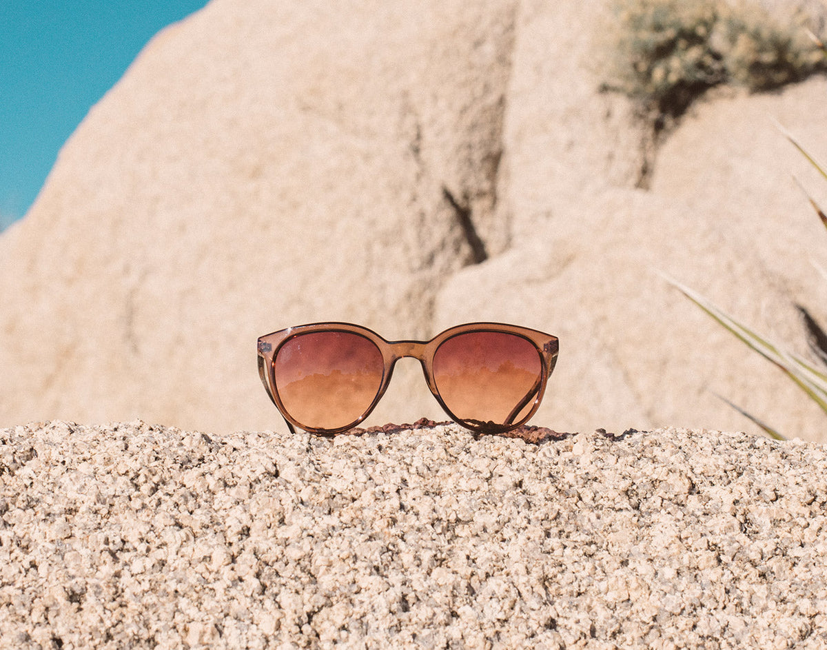 STORY sunski makani sunglasses sitting on a rock