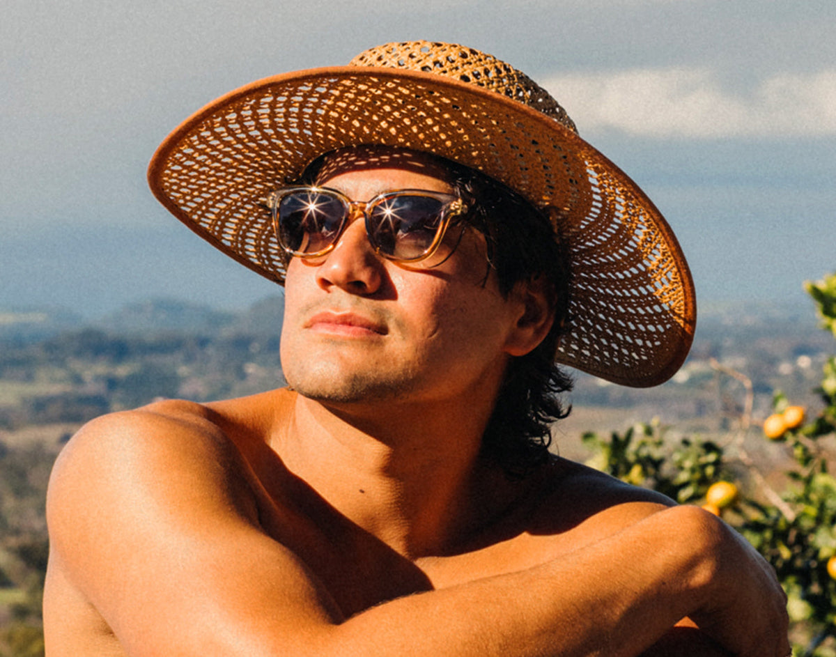 STORY guy in a straw hat wearing sunski miho sunglasses