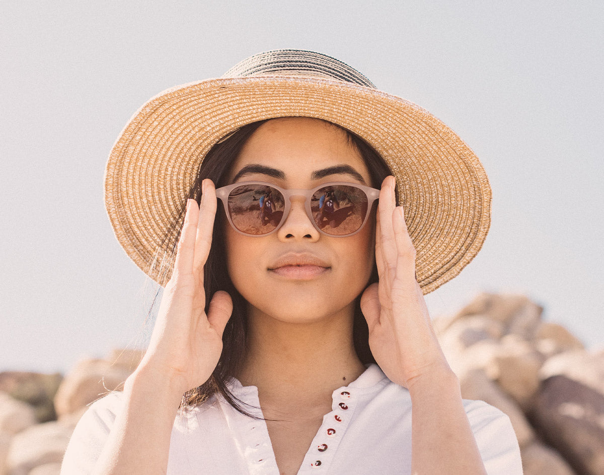 STORY girl in big hat wearing sunski yuba sunglasses