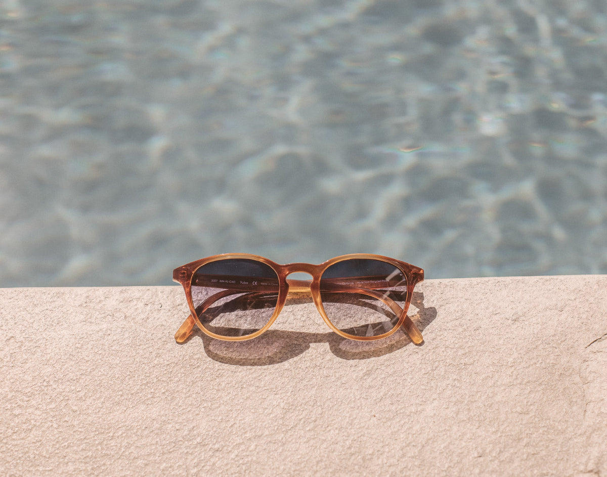 STORY sunski yuba sunglasses on edge of pool
