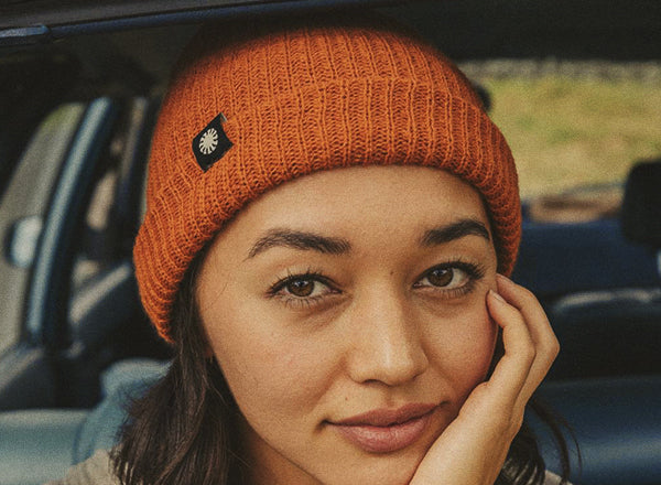RICH close up of girl wearing sunski shoulder season beanie