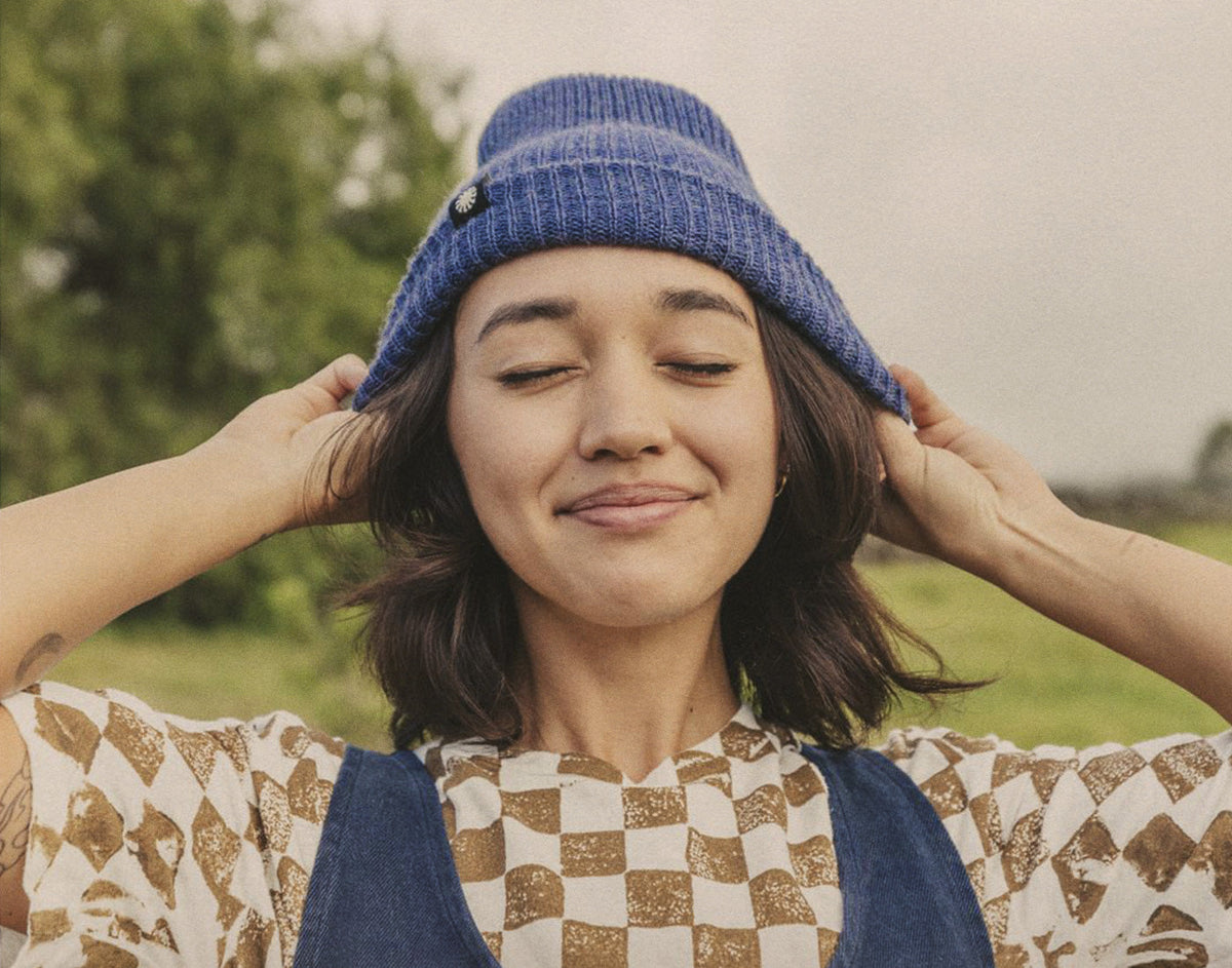 STORY girl smiling wearing sunski shoulder season beanie