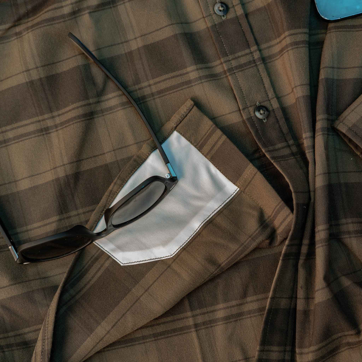 closeup of lens cloth on flannel shirt