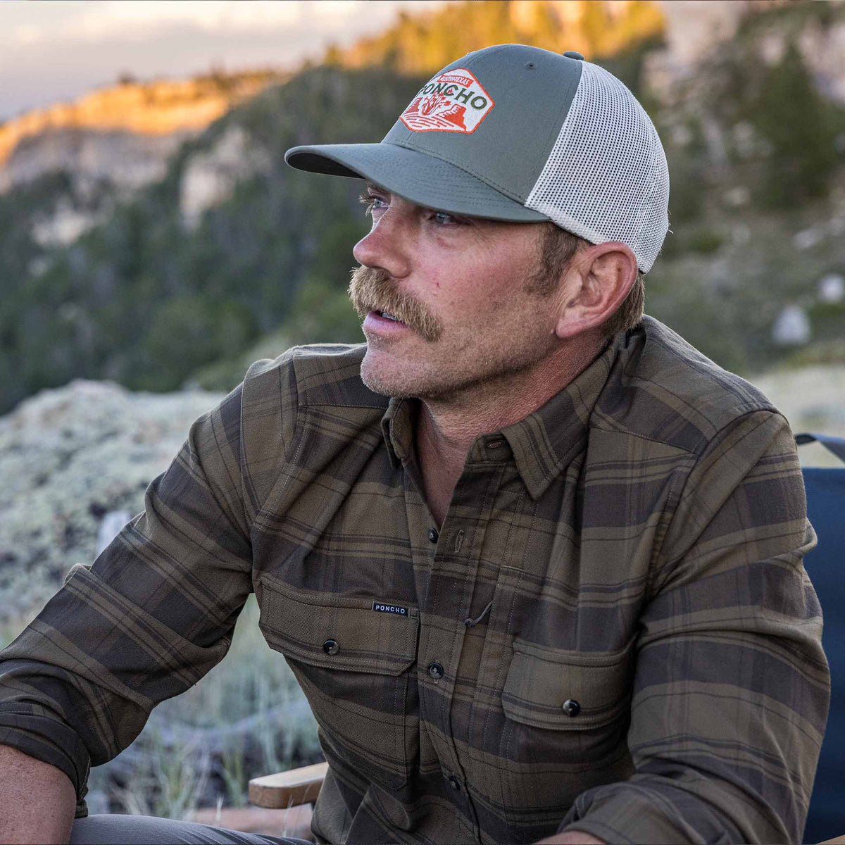 guy wearing flannel sitting outside